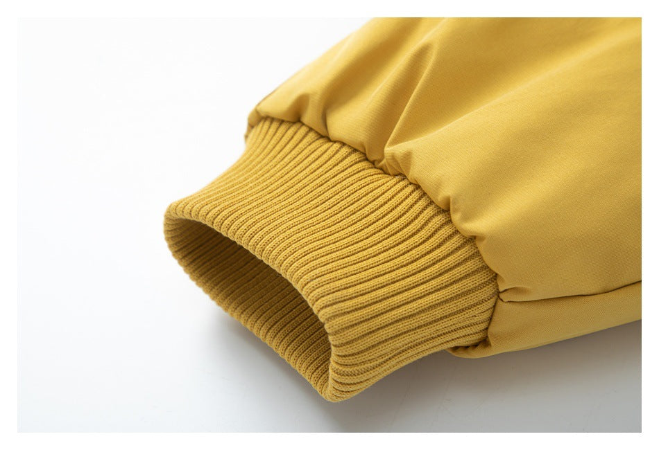 Close-up of a mustard-yellow sleeve with a wide ribbed cuff.