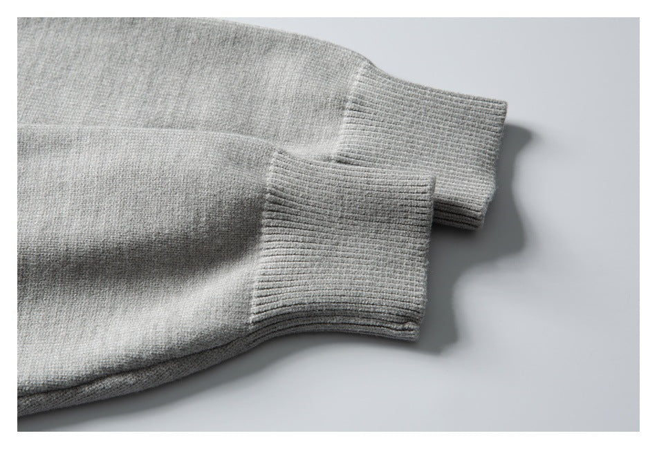 Close-up of the light gray sweater's ribbed sleeve cuffs.