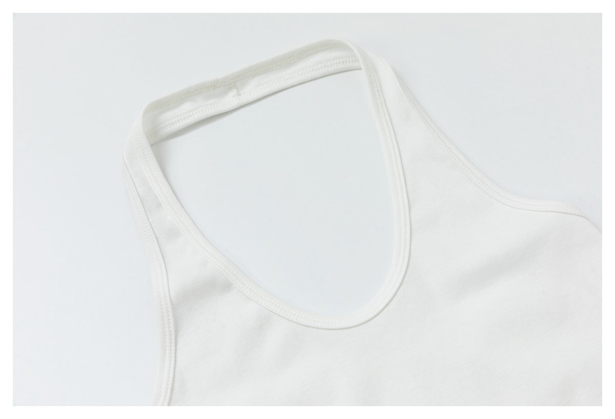 Angled close-up of a white sleeveless top’s rounded neckline and shoulder straps.