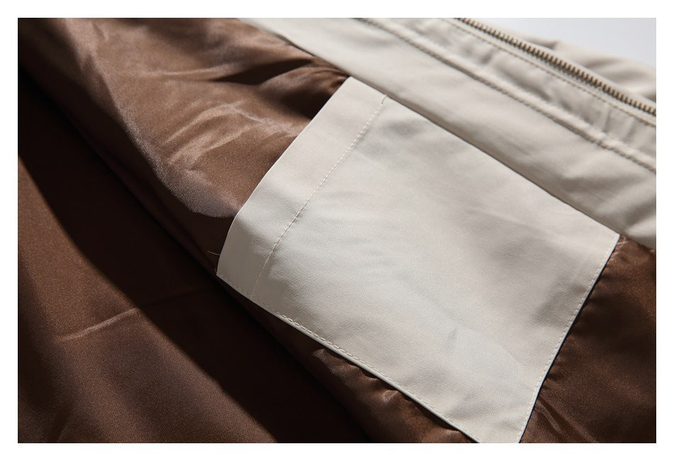 Close-up of brown and light beige garment panels, showing stitching and a zipper along the upper edge.