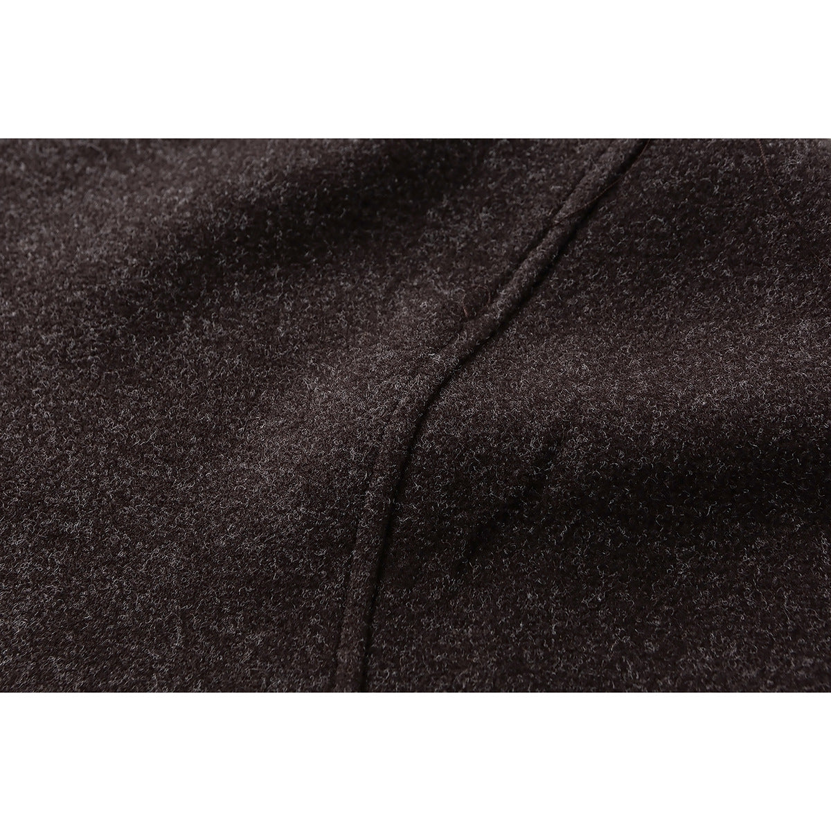 Close-up of dark brown heathered fabric and a stitched seam.