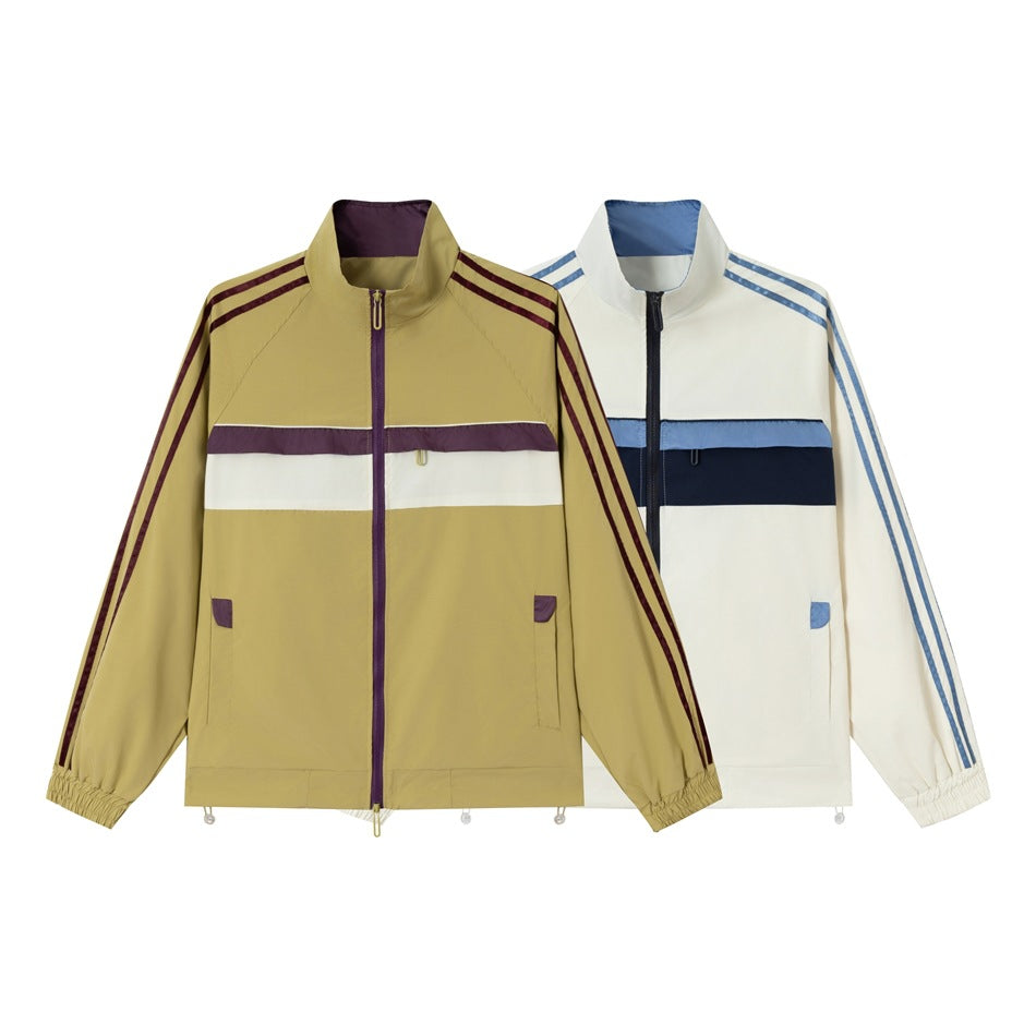 Two front-view zip-up track jackets: khaki with purple-and-white stripes and white with blue-and-navy stripes.