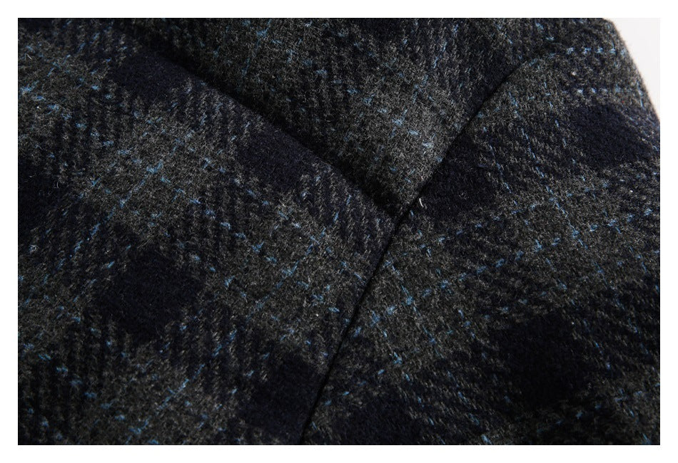 Close-up of the jacket's dark plaid fabric and a diagonal seam.