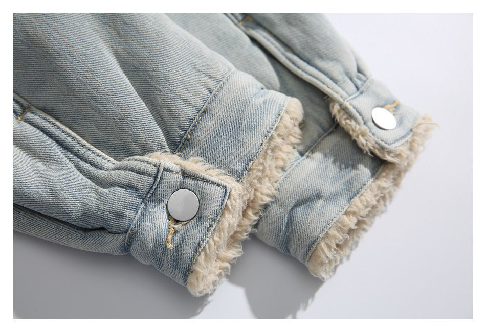 Close-up of a light blue denim jacket cuff with cream fleece lining and silver snap buttons.