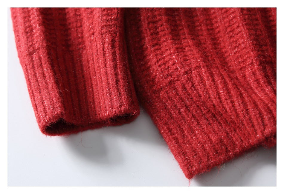 Close-up of a red ribbed sleeve cuff beside the garment's ribbed hem.