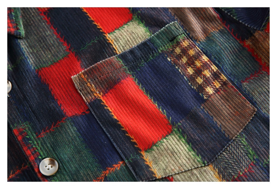 Close-up of a chest pocket, button and multicolored patchwork fabric with visible ribbed texture.