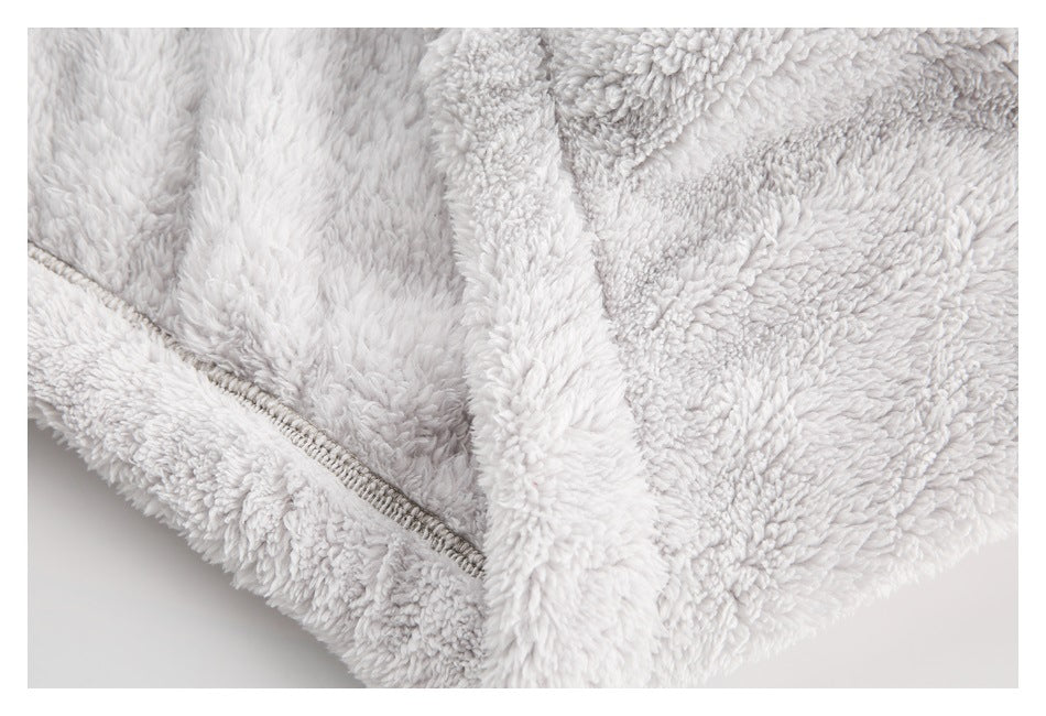 Close-up of a zipper and plush trim on a pale gray garment.