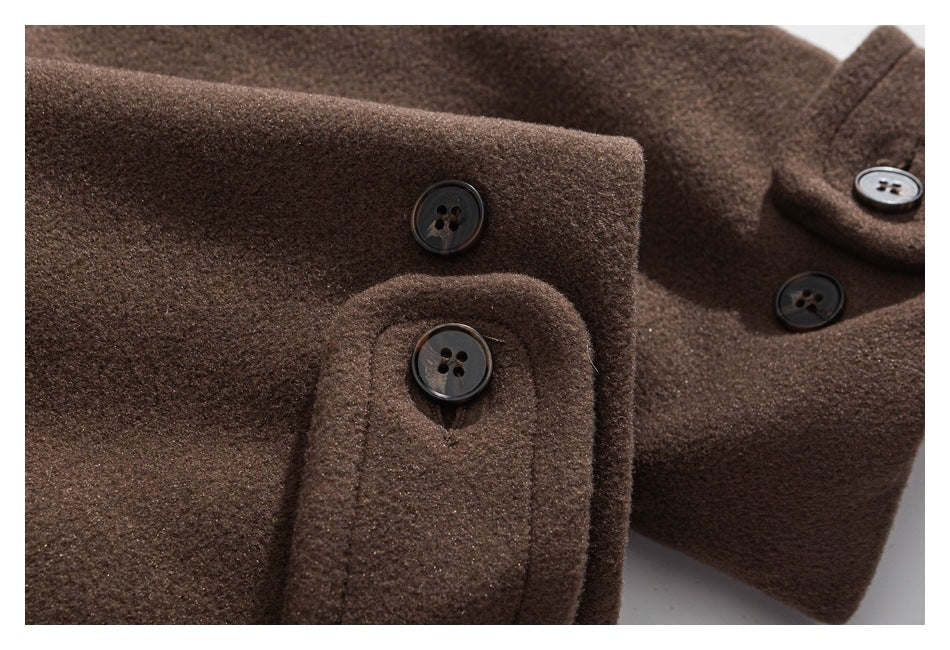 Close-up of a brown coat cuff with buttons, with the coat front visible behind it.