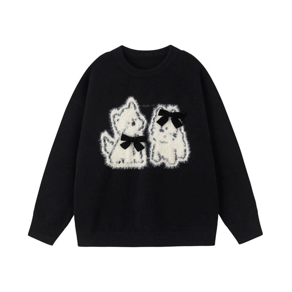 Black crew-neck sweater with two fuzzy cream cat appliqués wearing small black bows, flat front view