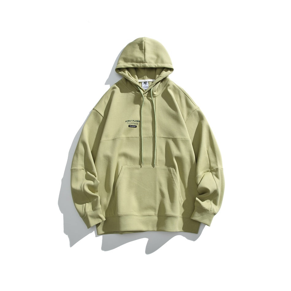 Grass green pullover hoodie flat lay with drawstring hood, kangaroo pocket, paneled seams and small chest print