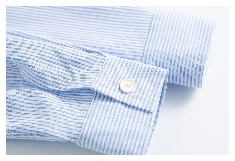 Close-up of a striped shirt cuff with a white button.