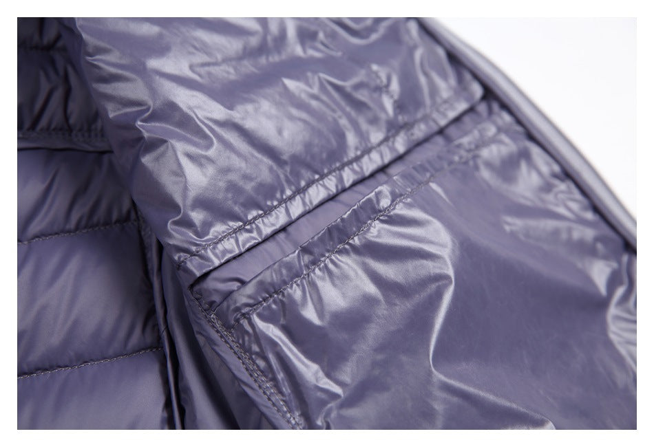 Close-up of a shiny purple-gray interior pocket and quilted jacket lining.