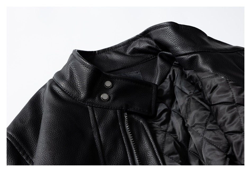 Close-up of the black jacket's snap-fastened collar, zipper and quilted inner lining.