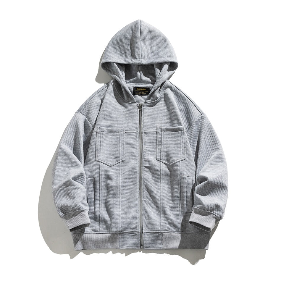 Gray waffle-knit zip-up hoodie with chest flap pockets and ribbed cuffs, flat lay front view