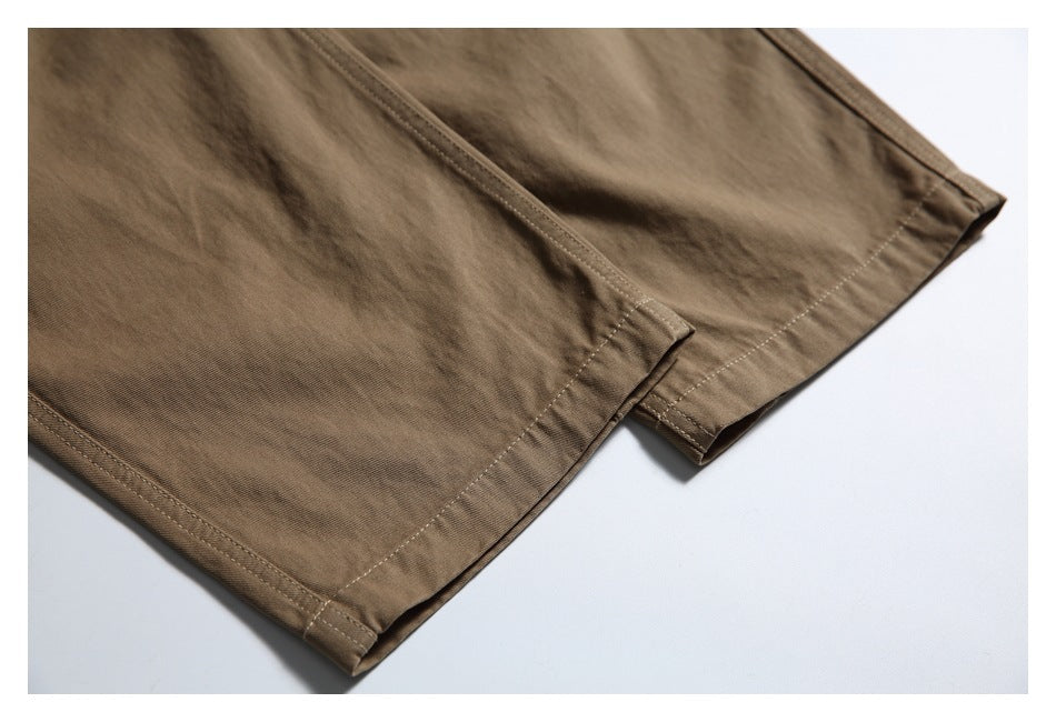 Close-up of the brown pants legs showing their stitched hems.