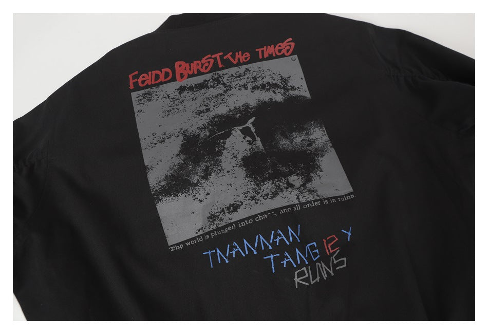 Back of a black jacket with a large gray graphic and red, blue, and gray text.