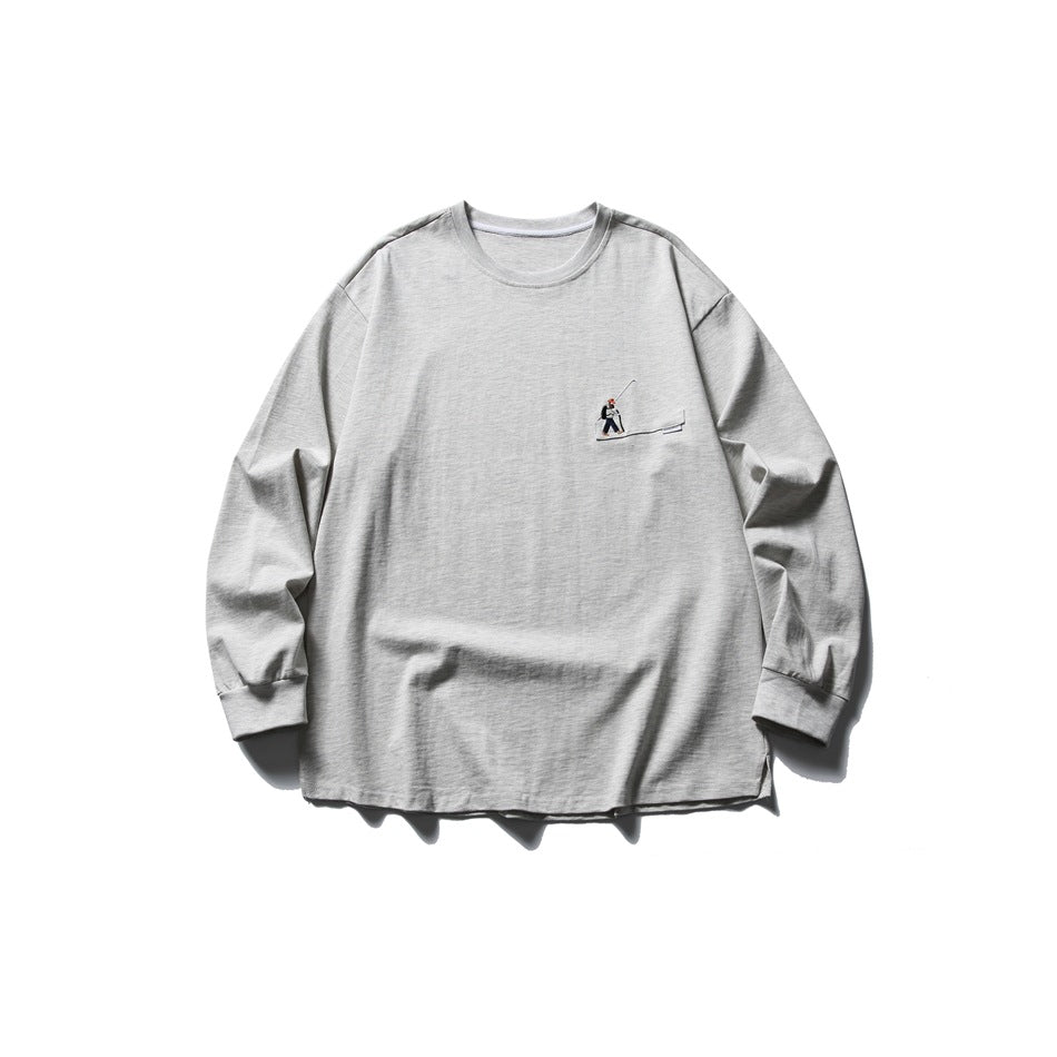 Light heather gray long-sleeve crew neck tee flat lay with a small embroidered hiker motif on the chest