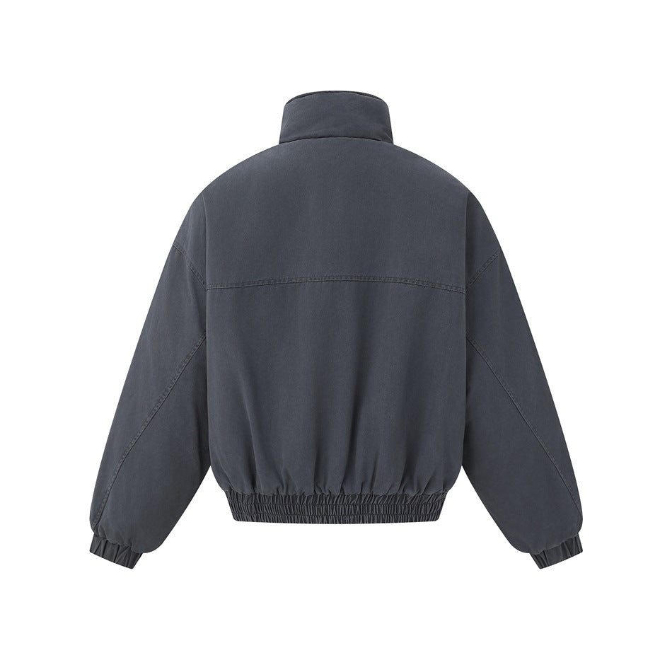 Back view of a charcoal gray jacket with a stand collar, dropped shoulders, and elasticated cuffs and hem.