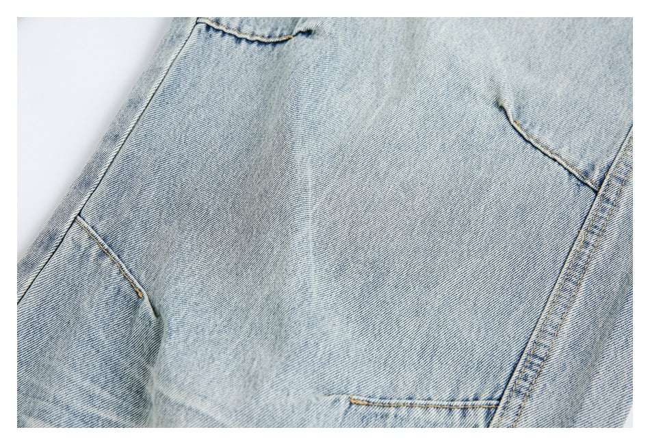 Close-up of light-wash denim showing pocket edges and contrast stitching.