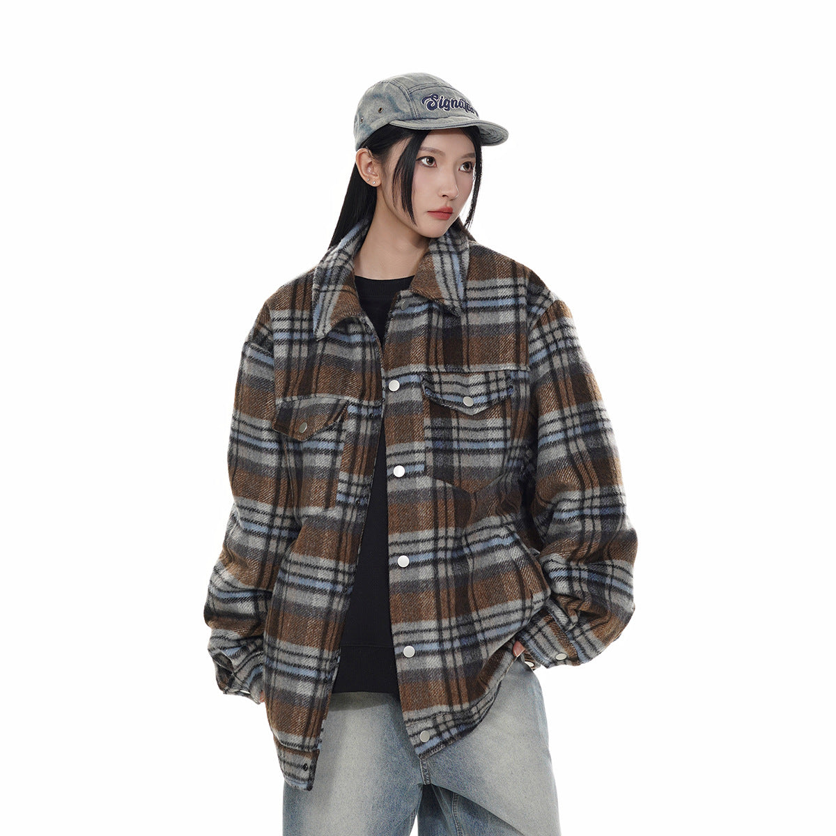 Model wearing a brown, gray, and blue plaid button-front jacket with flap chest pockets.