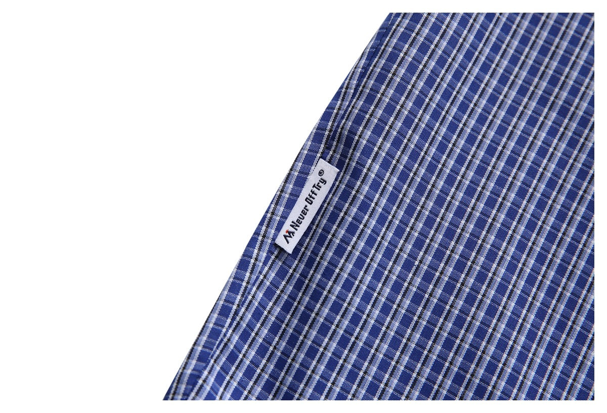 Close-up of a small sewn-in label on blue-and-white checked shirt fabric.