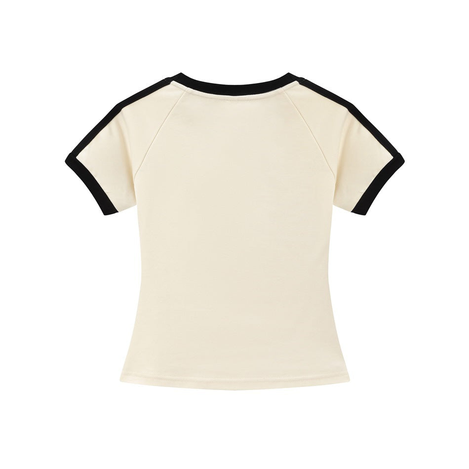 Back view of a cream short-sleeve raglan tee with black neckline and sleeve trim.