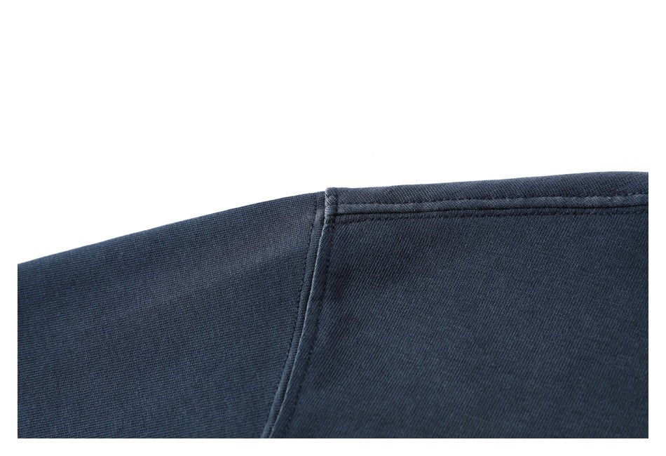 Close-up of a dark navy shirt shoulder seam and stitching.