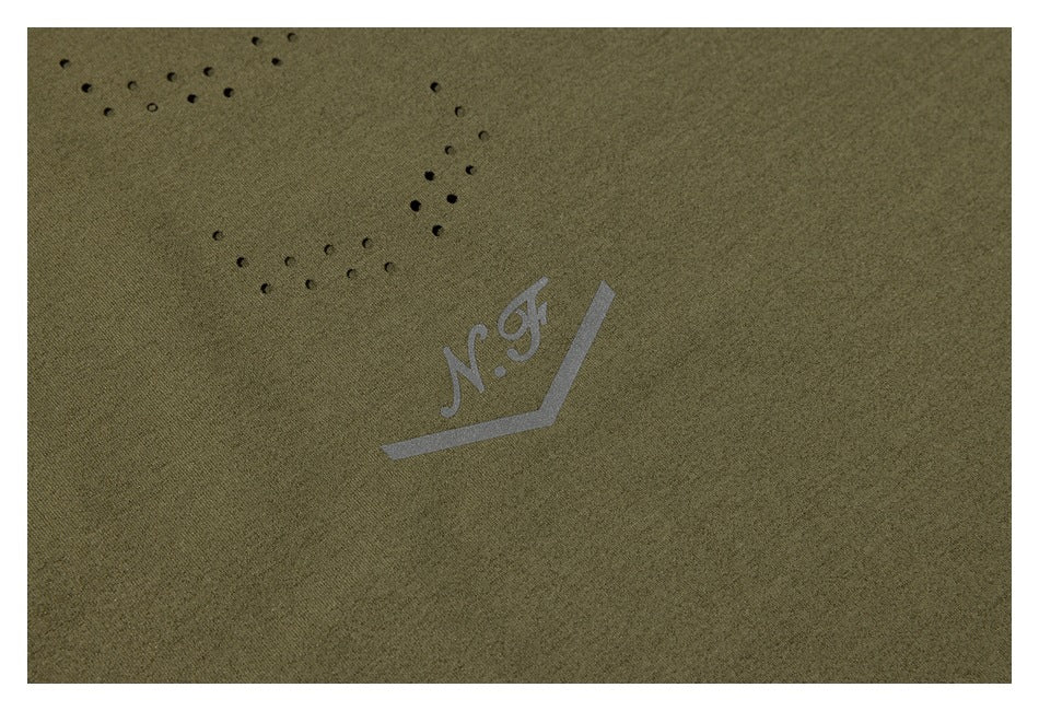 Close-up of dotted perforations and a small N.J. print on olive-green fabric.