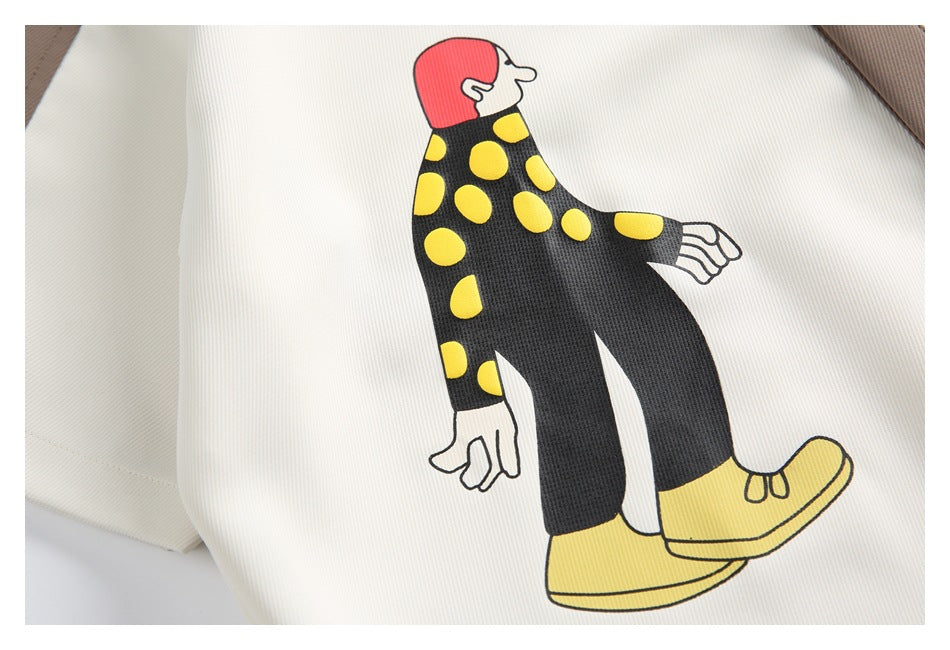 Close-up of a printed figure in a black outfit with yellow dots and yellow shoes.