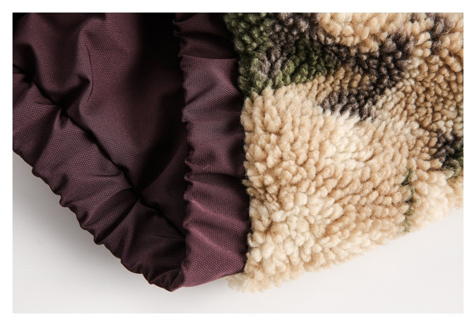 Close-up of beige camouflage fleece beside a gathered dark plum lining.