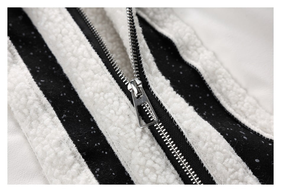 Close-up of the silver zipper and black-and-white speckled panels on a fleece-trimmed jacket.