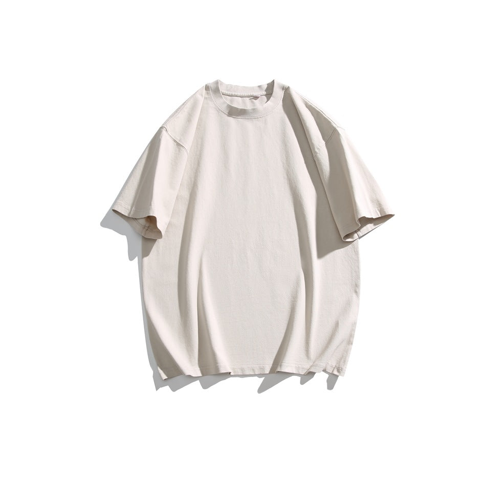 Sand beige short-sleeve crew neck T-shirt with dropped shoulders, flat lay on a white background