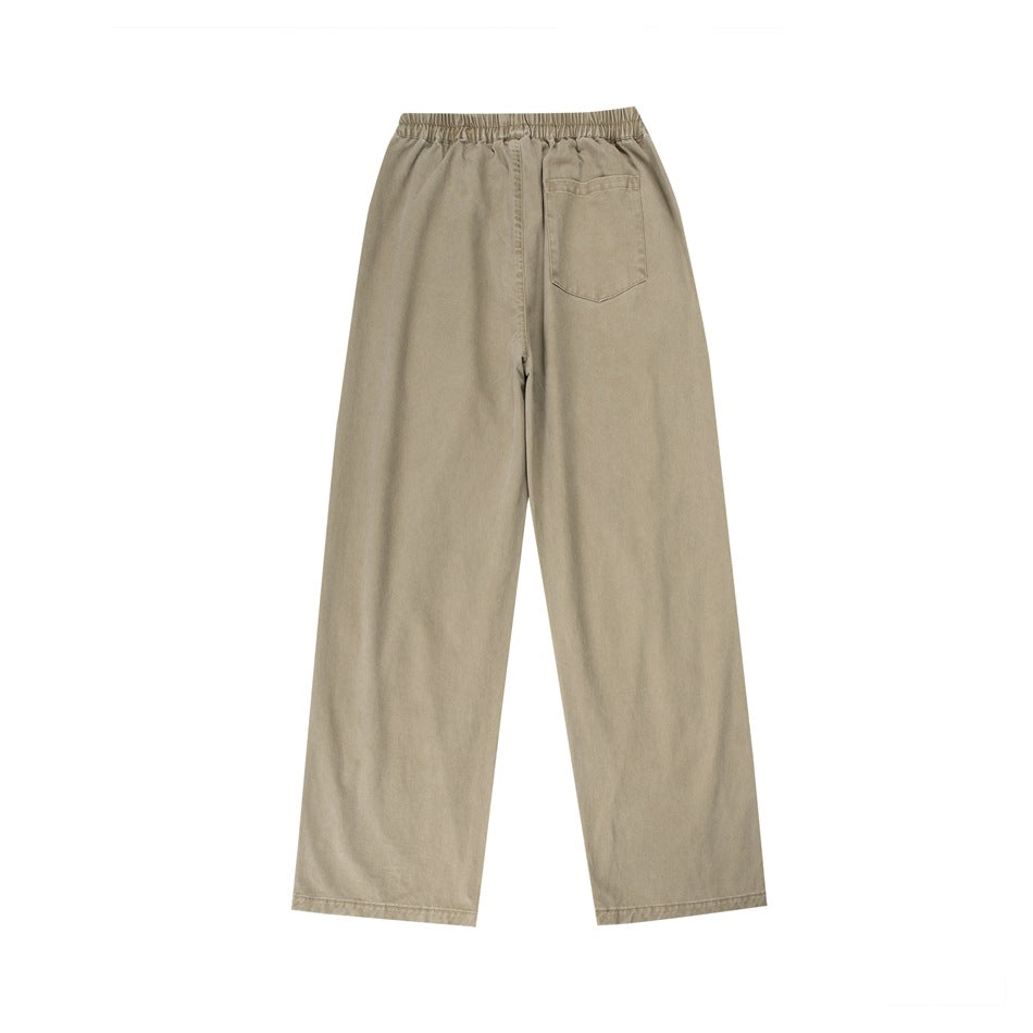 Back view of beige wide-leg pants with an elastic waistband and a single back patch pocket.