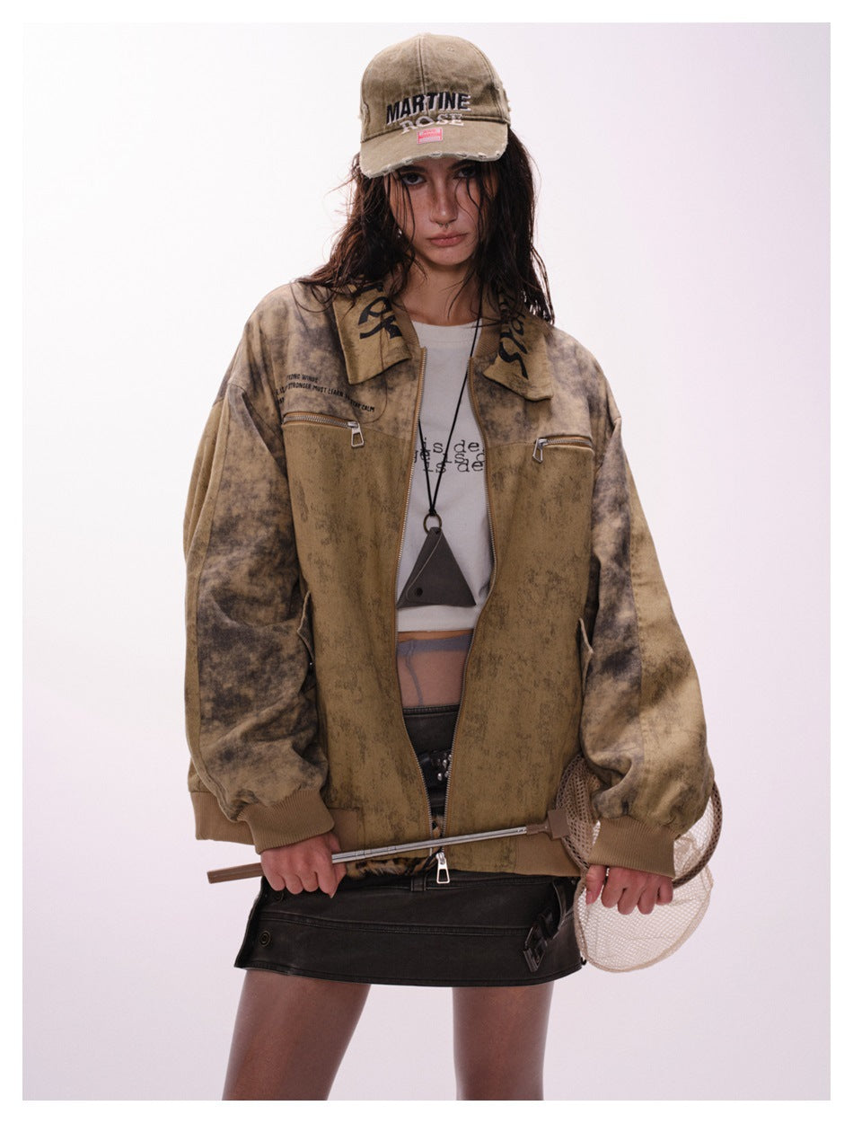 Front view of a model wearing an open mottled tan-brown jacket with darker sleeves and zip chest pockets.