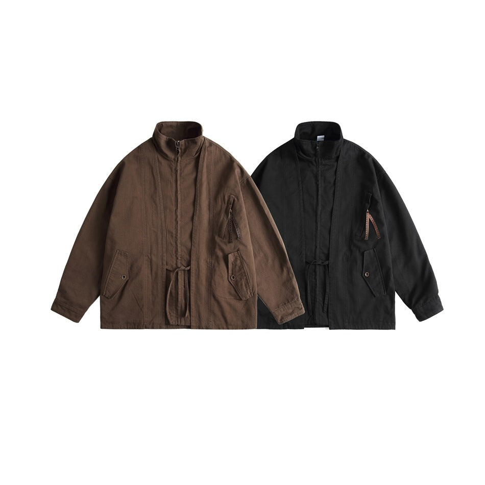 Front views of the same stand-collar jacket in brown and black, each with a zipper, waist tie, and pockets.