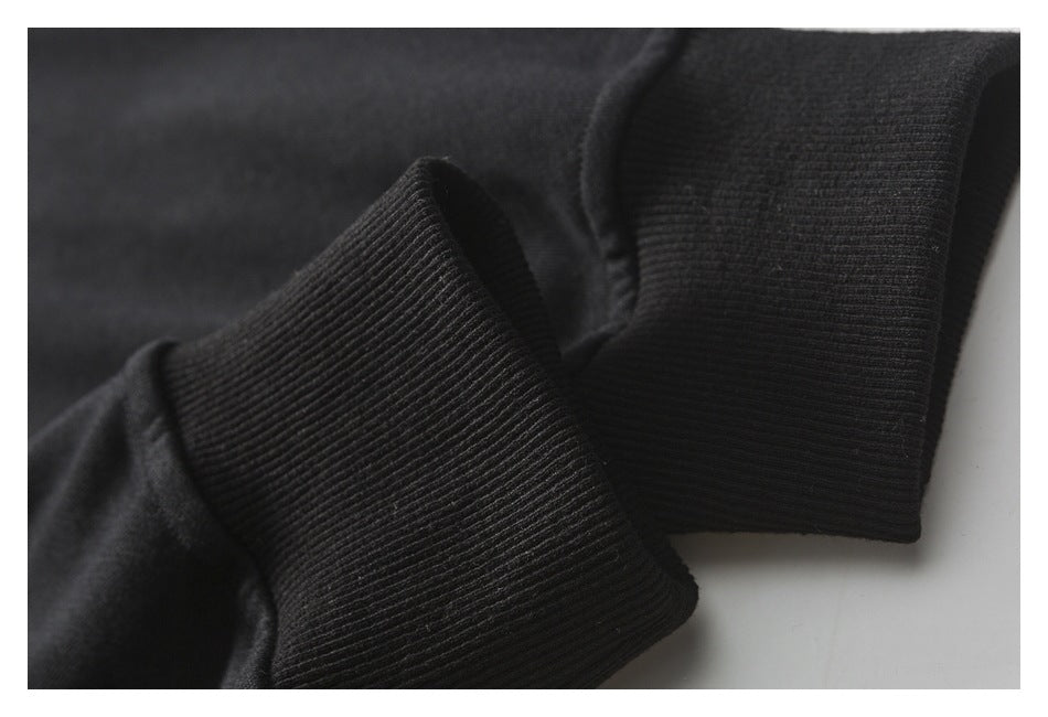 Close-up of the sweatshirt's black rib-knit cuff and sleeve fabric.
