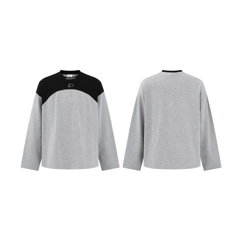 Front and back flat views of a gray long-sleeve top with black shoulder yoke, shown side by side