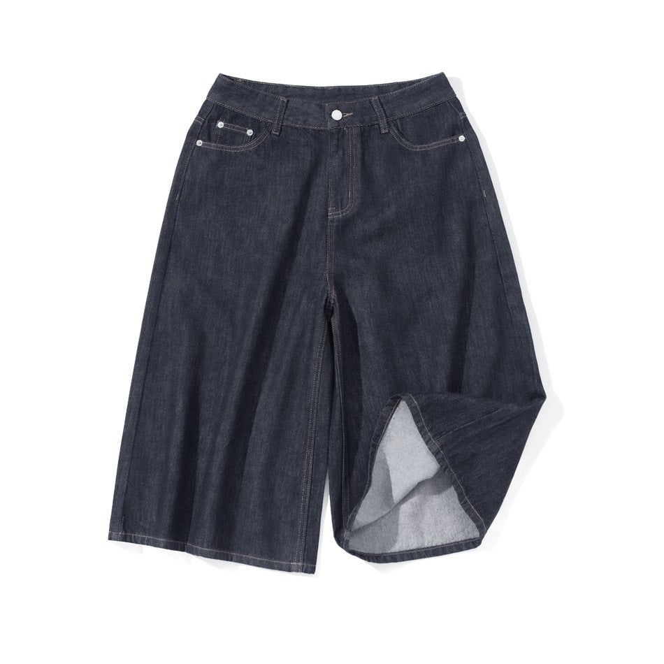 Dark denim wide-leg shorts flat lay with one leg hem folded up to show the lighter inside fabric