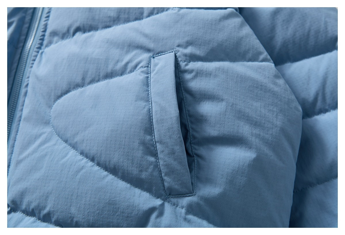 Close-up of a light blue jacket's vertical pocket opening and quilted panels.