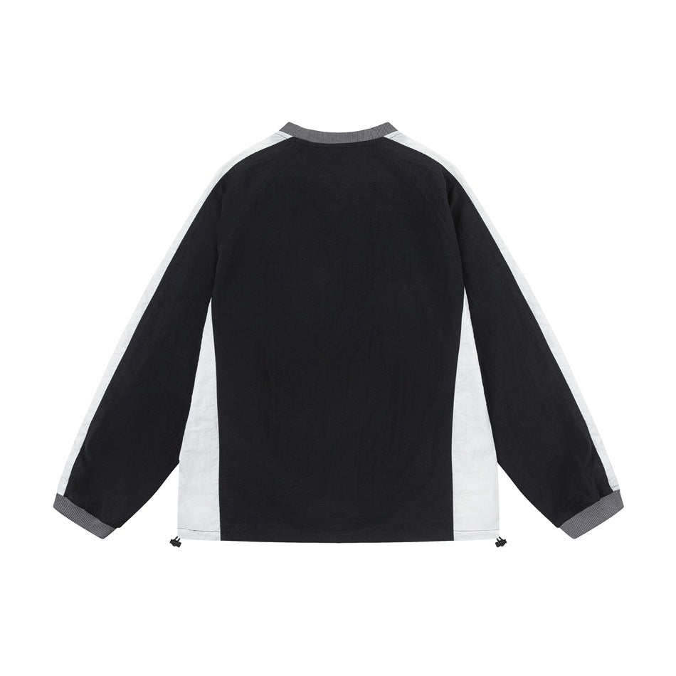 Back of a black long-sleeve top with off-white side and sleeve panels, gray ribbed collar and cuffs, and hem drawcords.