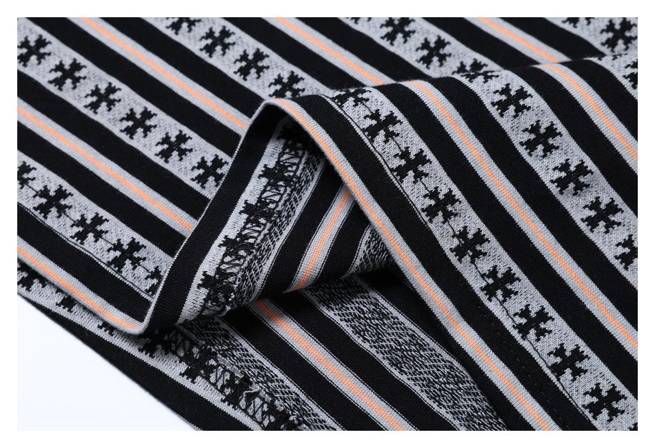 Folded edge of striped garment fabric showing the underside and stitching.