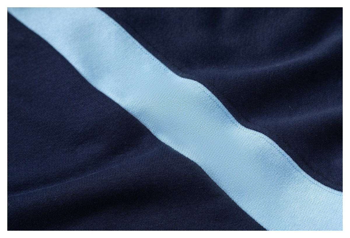 Close-up of navy fabric with a broad light blue stripe.
