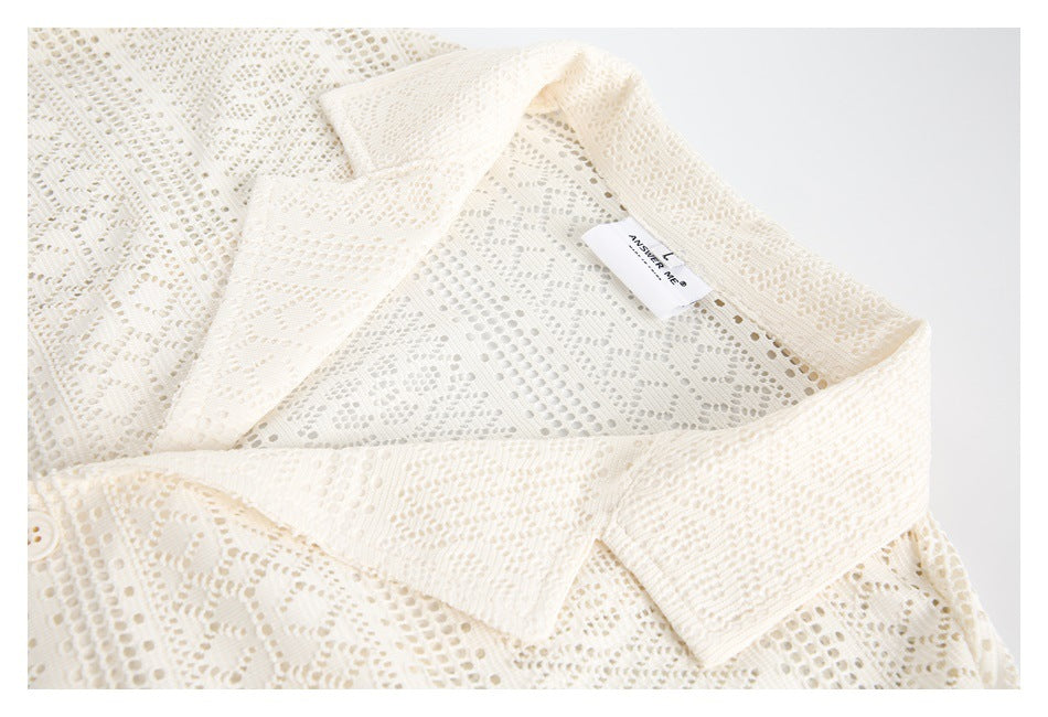 Close-up of an ivory openwork lace shirt collar and sewn-in neck label.