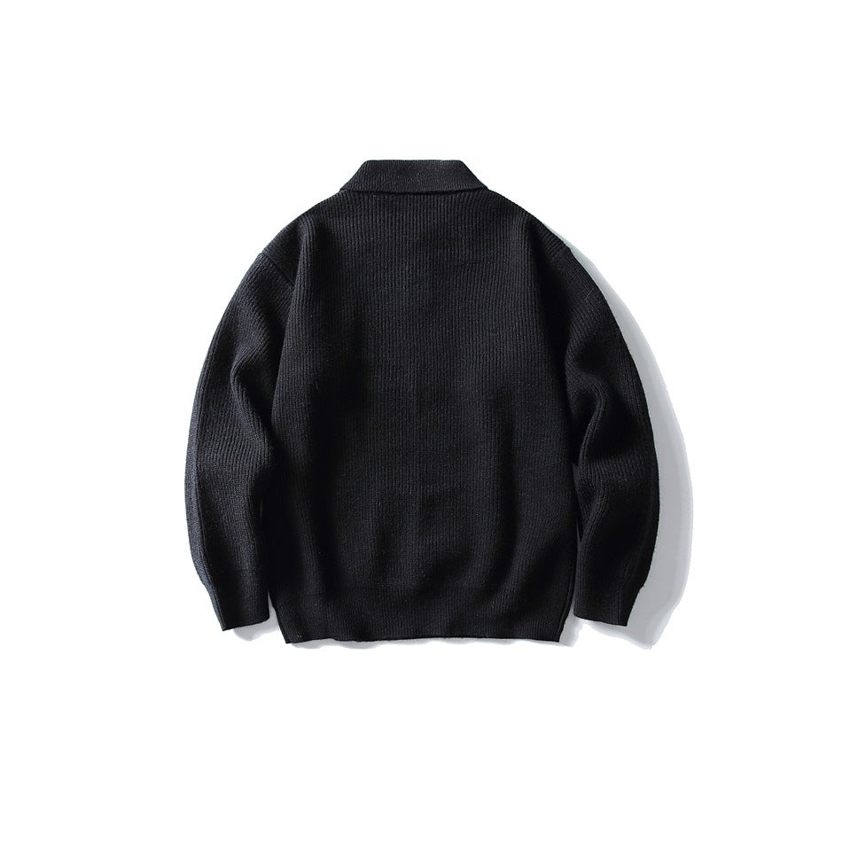 Black ribbed knit sweater, flat lay back view with folded collar