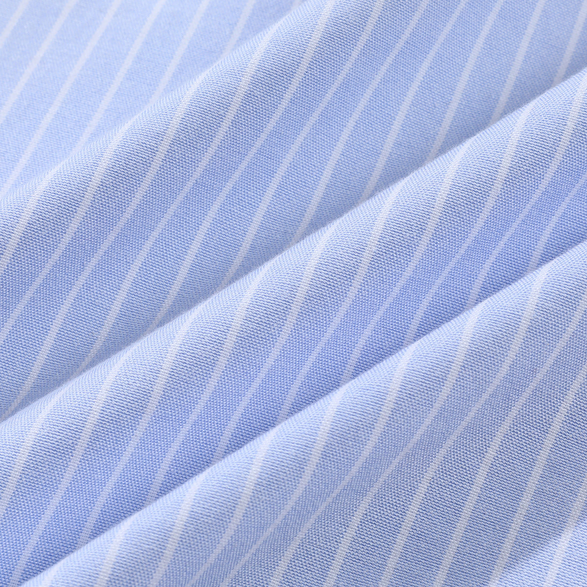 Close-up showing the light blue and white striped shirt fabric and its woven texture.