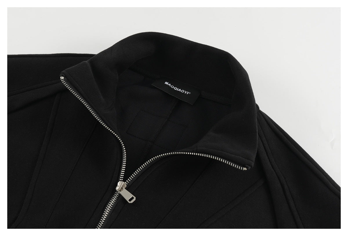 Close-up of the black jacket's open collar, silver zipper and inner neck label.