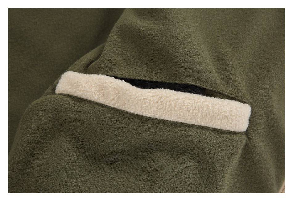 Close-up of an olive jacket pocket with a cream fleece-trimmed opening.