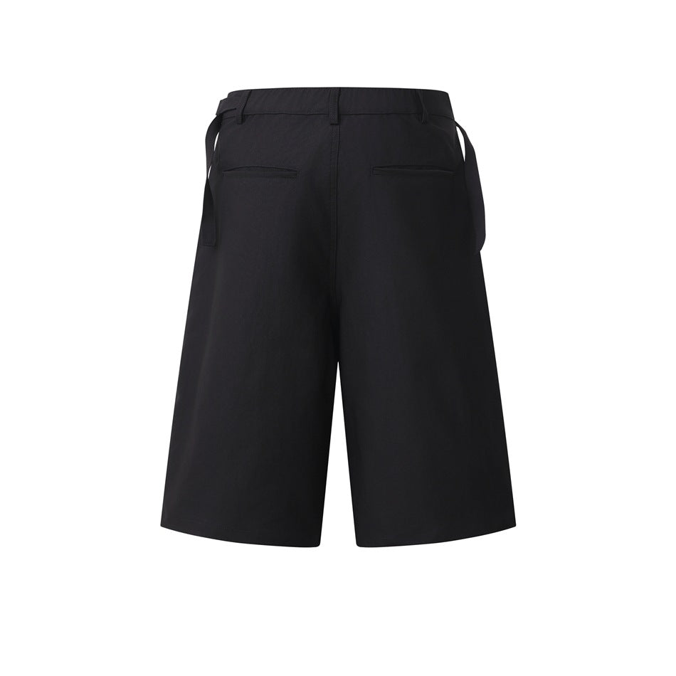 Rear view of black wide-leg shorts with belt loops, two welt pockets, and hanging side adjuster straps.