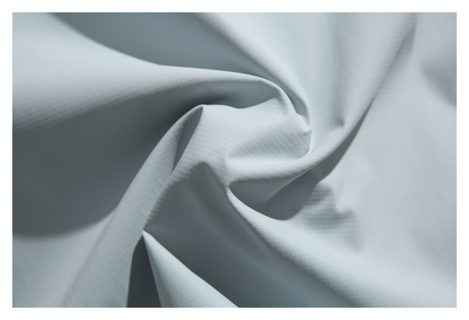 Close-up of pale blue-gray fabric draped into soft folds.