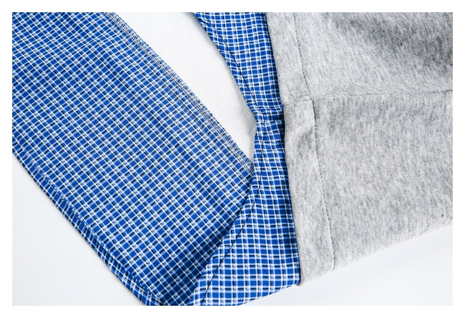 Close-up of blue-and-white plaid lining beside heather gray fabric and a stitched seam.